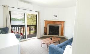 a living room with a couch and a fireplace at Bonnie View Inn in Haliburton +197 photos
