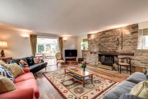 a living room with a couch and a fireplace at Meadow Cottage in Bicester