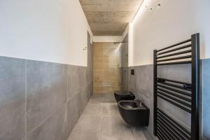 a bathroom with two toilets and a sink at Thalerhof Naturae Oasis Ritten in Auna di Sotto +25 photos