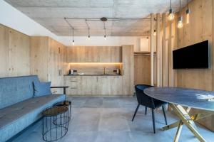 a living room with a couch and a table at Thalerhof Naturae Oasis Ritten in Auna di Sotto