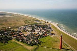 an aerial view of a town next to the ocean at Eb en Vloed in Huisduinen