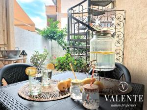 a table with a glass jar on top of it at Il Giardino del Mare -3 Minuti Dalla Spiaggia- in Torre del Lago Puccini
