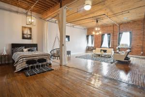 a loft with a bed and a living room at Queen G Investments apts in Detroit