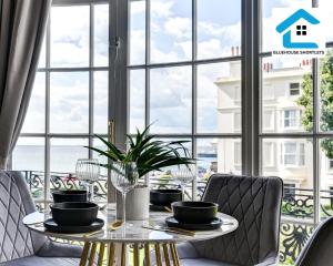 a dining room with a table in front of a window at Seaside Apartment By Bluehouse Short Lets Brighton With Stunning Views Leisure Family in Brighton & Hove