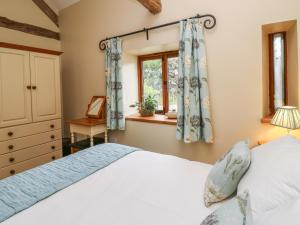 a bedroom with a bed and a window at Nant Glas in Llanwrda