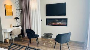 a living room with chairs and a fireplace on the wall at Palazzo Gatto Bianco in Bari