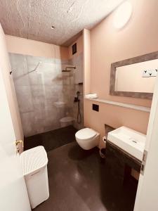 a bathroom with a toilet and a sink and a shower at Zweirad Hotel Lenne in Schwerin