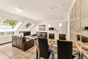 a large living room with a table and chairs at Grashaus Upleward in Krummhörn