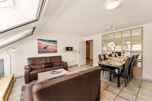 a living room with a couch and a table at Grashaus Upleward in Krummhörn