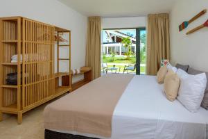 a bedroom with a large white bed and a balcony at Amar'e Aparthotel & Spa in Las Terrenas
