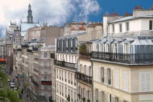 a group of buildings on a city street at Hotel Aida Marais in Paris