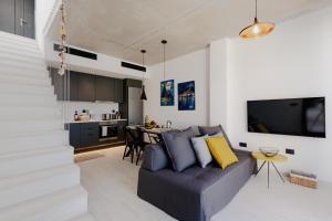 a living room with a couch and a kitchen at Villa Aktio in Paleros