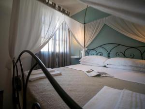 a bedroom with a large bed with a large window at Locanda dei Sette Limoni in Vada