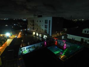 a view of a building with a pool at night at HOTEL ROMENEO in Lagos