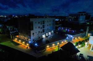 a large building with lights in a city at night at HOTEL ROMENEO in Lagos