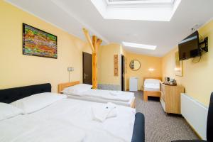 a hotel room with two beds and a tv at Hotel Max in Prague +28 photos