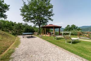 a gazebo with a picnic table and two chairs at Pugnano Alto -appartamento Castagna in Lisciano Niccone