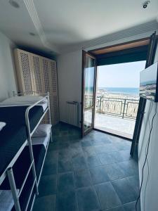 a bedroom with a bunk bed and a view of the ocean at NEWHOUSE VICTORIA in Nettuno