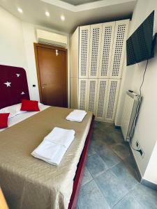 a bedroom with a bed with two towels on it at NEWHOUSE VICTORIA in Nettuno