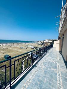 a balcony with a view of the beach at NEWHOUSE VICTORIA in Nettuno