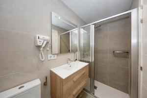a bathroom with a sink and a shower and a mirror at Wayteko Boutique Hotel in Alicante