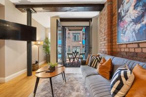 un soggiorno con divano e muro di mattoni di Host & Stay - Queen Square Apartment a Liverpool