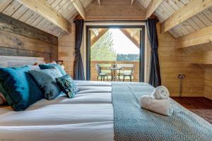 a bedroom with a large bed and a large window at Buttercup Lodge in Benson
