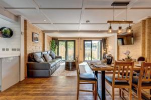 a kitchen and living room with a table and a couch at Buttercup Lodge in Benson
