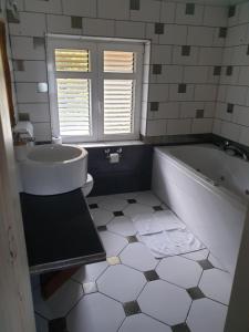 a bathroom with a tub and a sink and a toilet at VILLA BISER in Mošćenička Draga