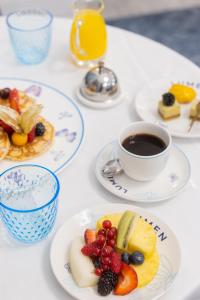 una mesa con platos de comida y una taza de café en The St. Regis Rome en Roma