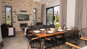 a dining room and living room with a table and chairs at Bodrum Ortakent Luxury Private Villa with Pool in Bodrum City