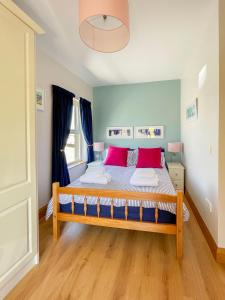 a bedroom with a large bed with red pillows at Mount Edwards Hill Guest Accommodation in Cushendall