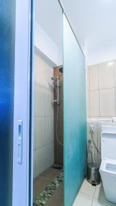 a bathroom with a shower and a toilet at Hotel Sapphire in Mombasa