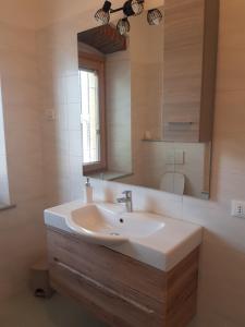 a bathroom with a sink and a mirror at Villa Montegolo in Costermano