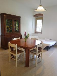 a dining room with a table and chairs and a bed at Villa Montegolo in Costermano