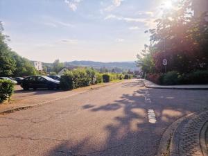 an empty street with cars parked on the side of the road at Wasserfälle Apartments in Sasbachwalden