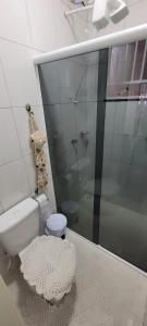 a bathroom with a toilet and a glass shower at Casa mobiliada recém reformada in Matinhos +10 photos