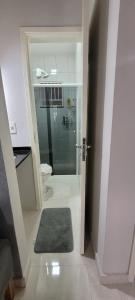 a bathroom with a shower and a glass door at Casa mobiliada recém reformada in Matinhos