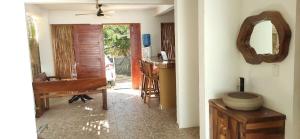 a living room with a table and a mirror at Casa Yoo Bigu Mazunte in Mazunte