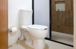 a white toilet in a bathroom with a shower at Casa Yoo Bigu Mazunte in Mazunte