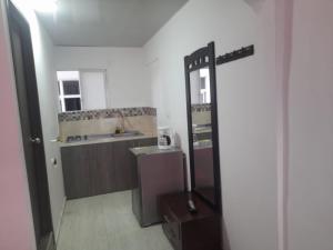 a bathroom with a sink and a mirror in a room at apartamento cali in Cali
