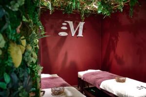 a red room with two tables and a sign that says x at Sky Business Hotel in Legnica