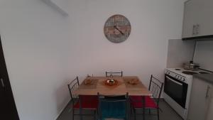 a kitchen with a table and a clock on the wall at Sweet Home in Rethymno