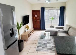 a living room with a couch and a table at NST City Apartments @ 9 Joubert in Nelspruit