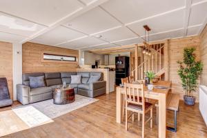 a living room with a couch and a table at Bluebell Lodge in Benson