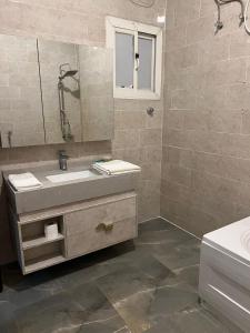 a bathroom with a sink and a mirror at Crystal Blue Hotel in Rabigh