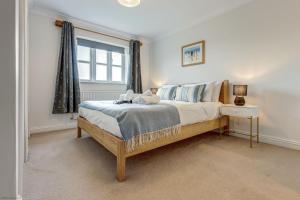 a bedroom with a large bed and a window at Walnut Cottage in Brackley
