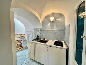 a kitchen with a sink and a counter top at Suite Apartment con Giardino in Piazzetta in Capri