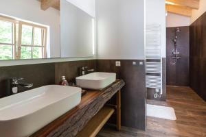 a bathroom with a white sink and a mirror at Dachstein Chalet in Russbach am Pass Gschütt