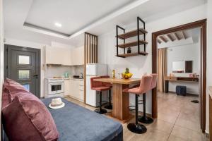a living room with a table and a kitchen at Marina apartments in Léntas